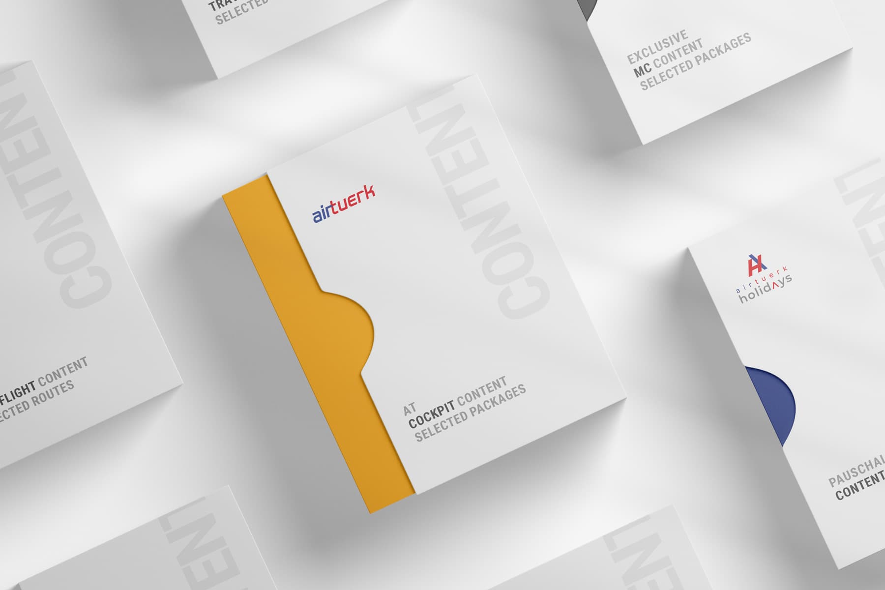 A set of airtuerk content packages arranged on a light grey surface, each carrying the wordmark, a coloured spine and a different content tier such as cockpit content, flight content and airtuerk holidays